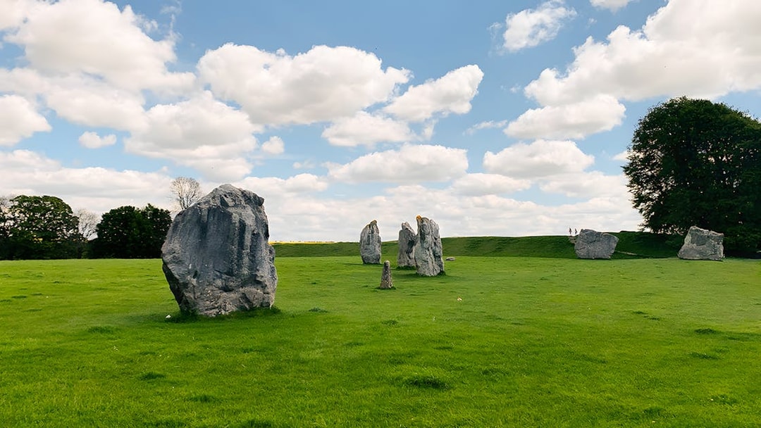 Avebury stone circle under a blue sky on a guided day tour from London.