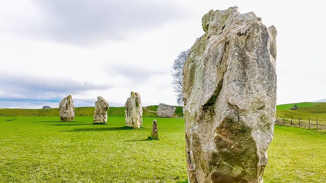 Avebury stone circle in a green field, part of a full-day tour from London.