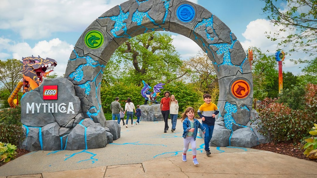 Entrance to LEGO MYTHICA at LEGOLAND® Windsor Resort with families walking through.