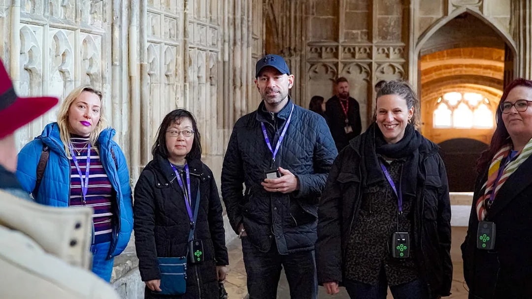 Visitors with guide and audio devices inside Windsor Castle.