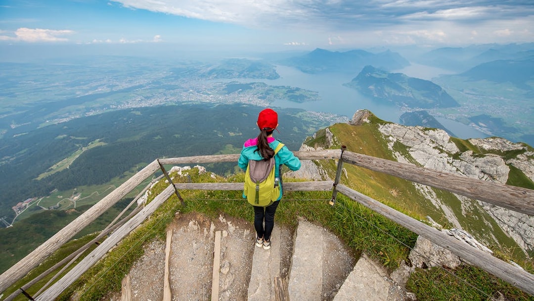 Tourist overlooking Lake Lucerne from Mt. Pilatus summit, Switzerland.