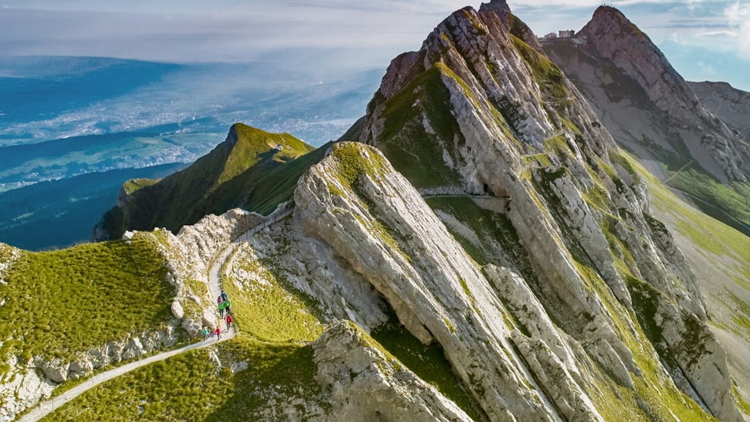 Hikers on a trail along the rocky peaks of Mount Pilatus, Lucerne.