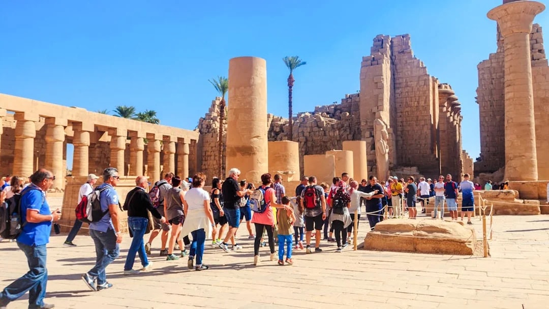 Visitors exploring Karnak Temple ruins during Luxor tour.
