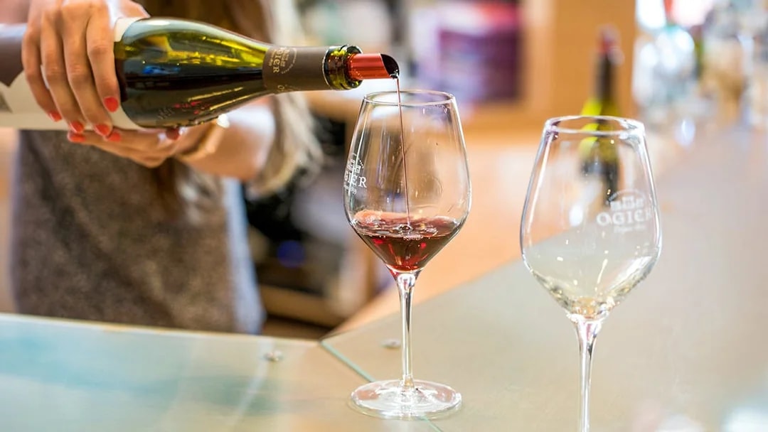 Wine tasting in Provence with red wine being poured into a glass.