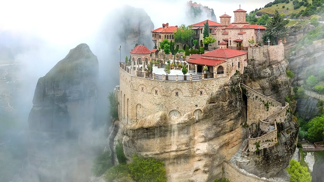 Varlaam Monastery perched on a misty cliff in Meteora, Greece.
