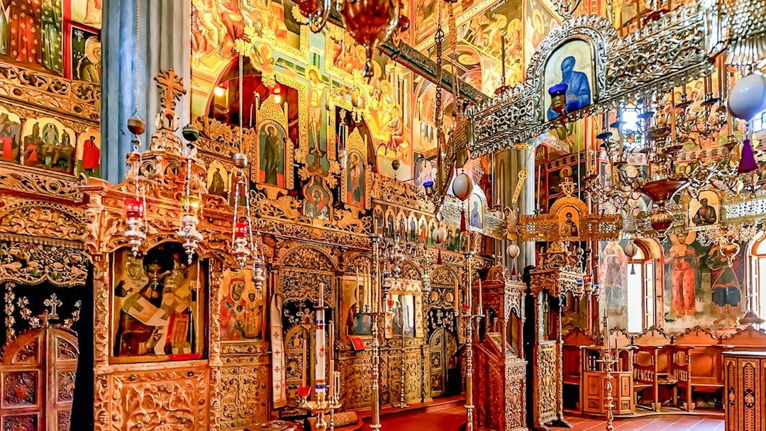 Interior of The Monastery of Great Meteoron with ornate religious icons and wooden carvings.