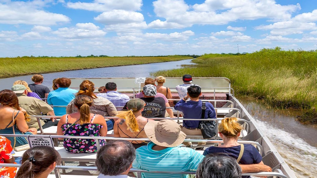 Tourists on an airboat ride through Everglades Safari Park, Miami.