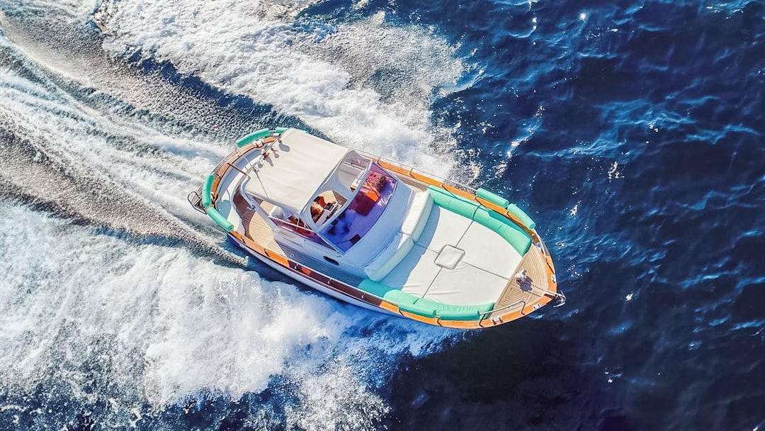 Boat cruising on blue waters during all-inclusive Capri tour from Pompeii or Naples.