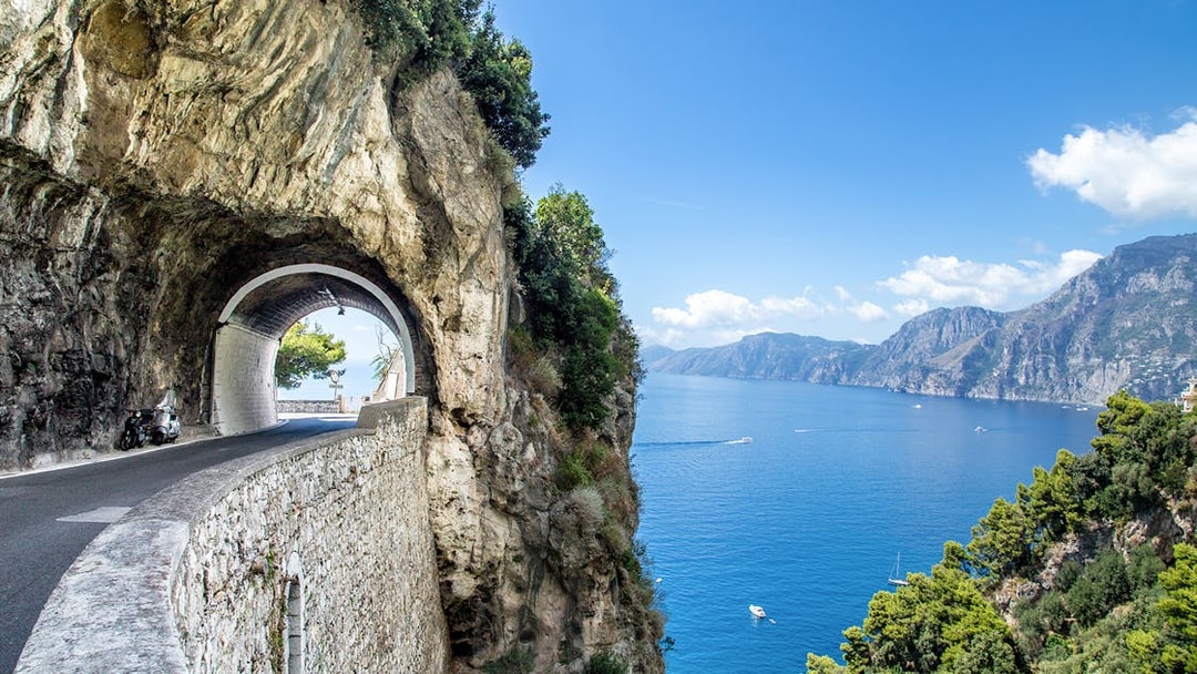Tunnel road along the Amalfi Coast with sea view, part of the Positano, Amalfi & Ravello tour.