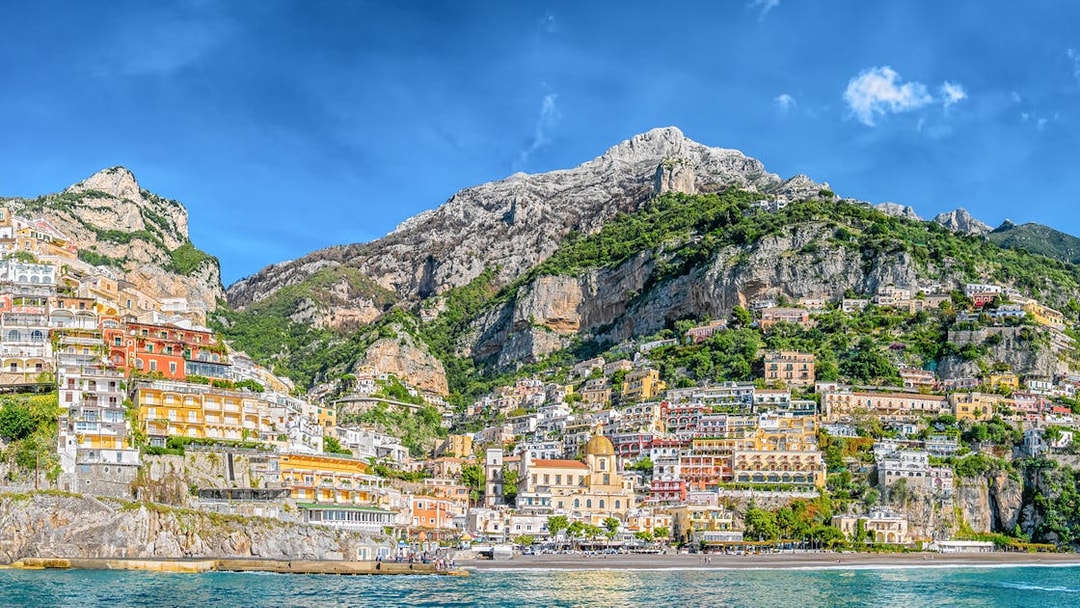 Positano cliffside view with colorful buildings and sea, part of Amalfi Coast tour from Naples.