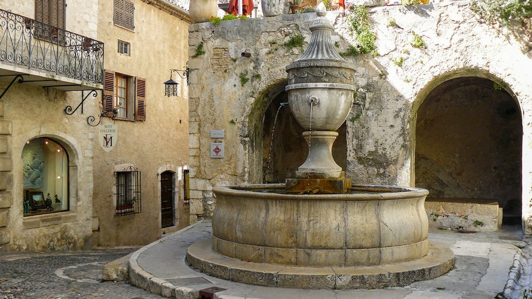 Stone fountain in a quaint street of a Provence village, France.