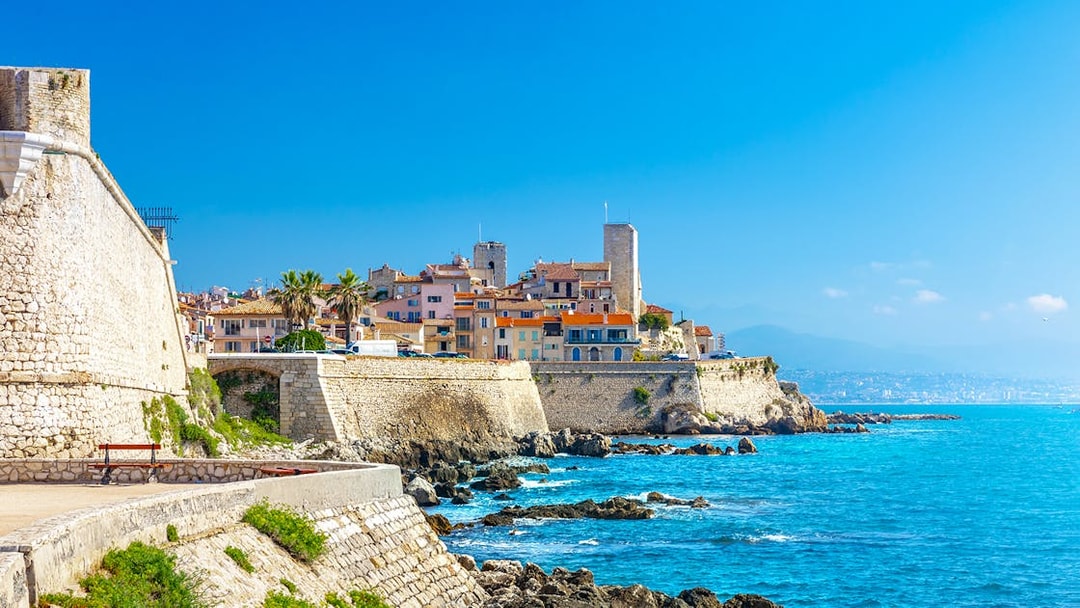 Old town of Antibes with stone walls and Mediterranean Sea in Provence, France.