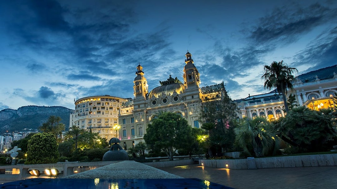 Monaco Casino illuminated at night during a guided tour from Nice.