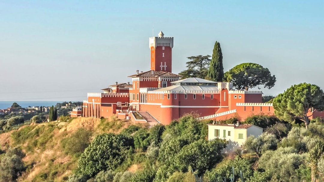 Provencal castle on a hill surrounded by greenery, part of a market and wine tasting tour.