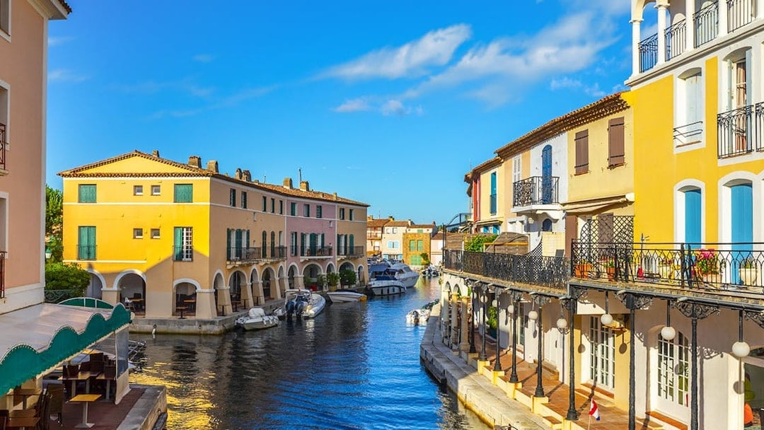 Colorful houses and boats along a canal in Port Grimaud, France.