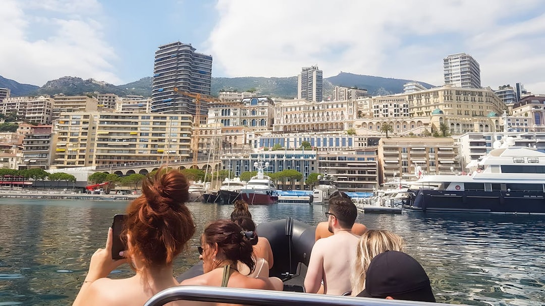Boat tour group viewing Monaco skyline from the water.