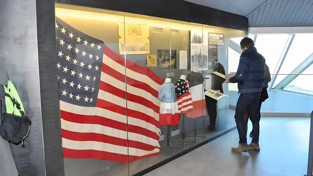 American flag display at Normandy museum exhibit, part of D-Day guided tour from Paris.