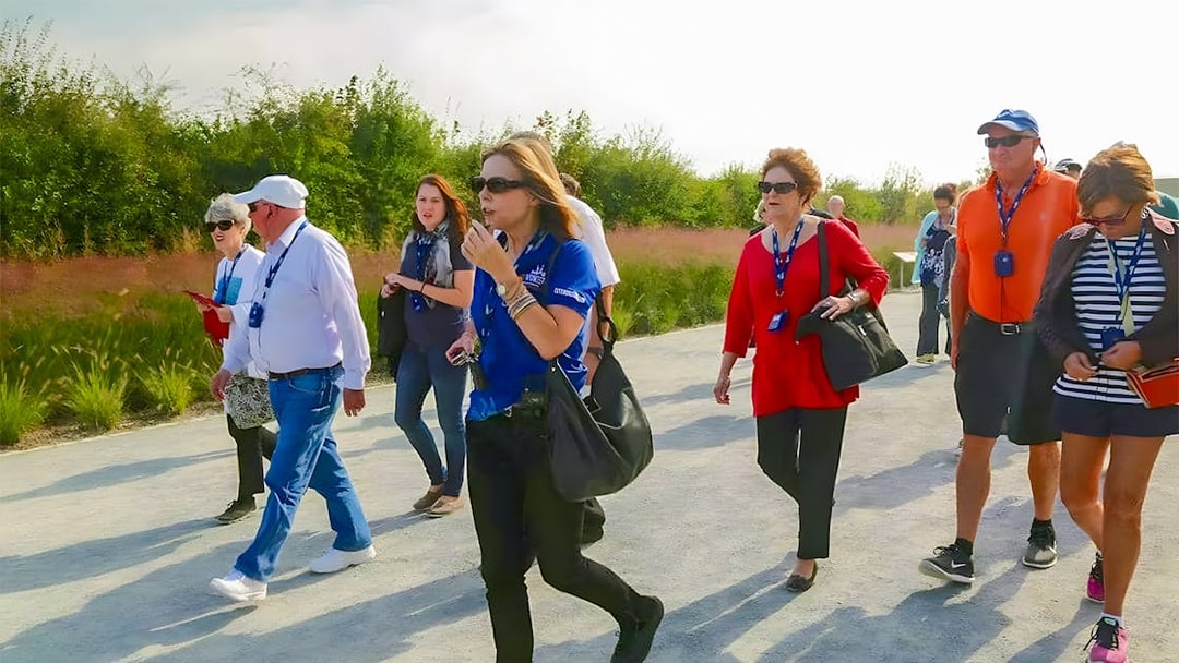 Tour group walking on a path during the D-Day Normandy Beaches guided tour.