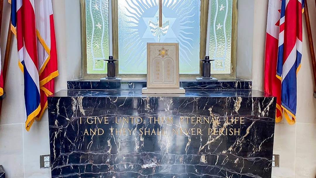 Memorial altar with flags at Normandy American Cemetery, D-Day Normandy Beaches Day Trip.