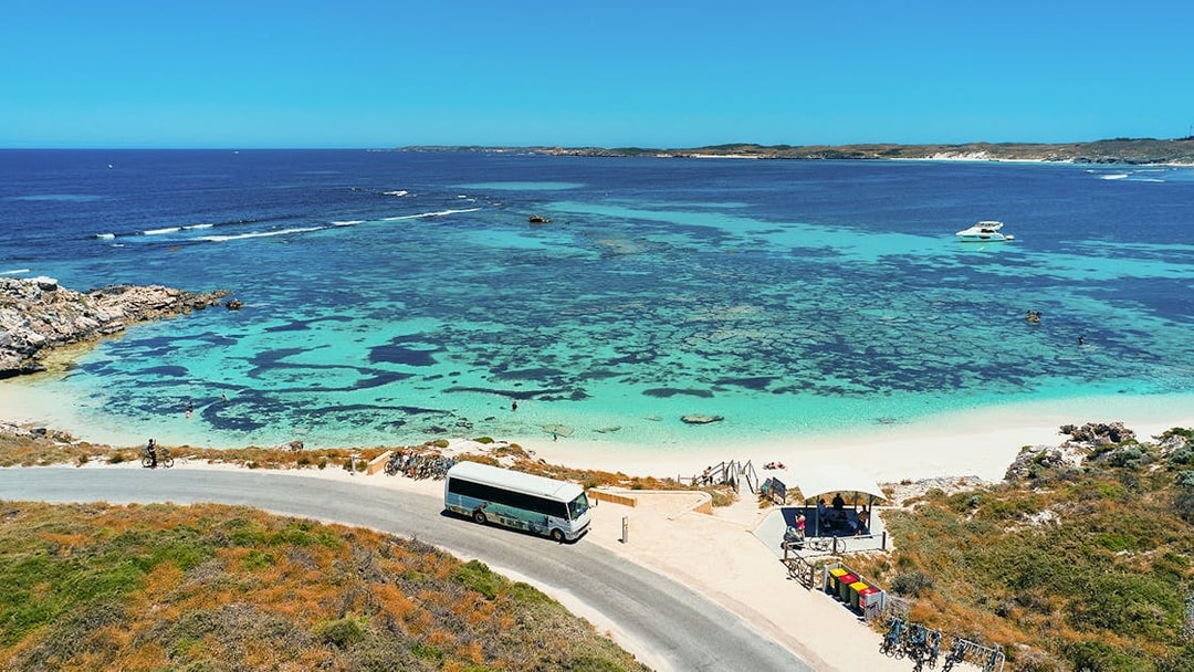 Tourists on a bus tour at Rottnest Island with coastline view, Perth or Fremantle return ferry.