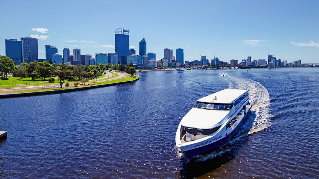 Cruise boat on Swan River with Perth skyline in the background.