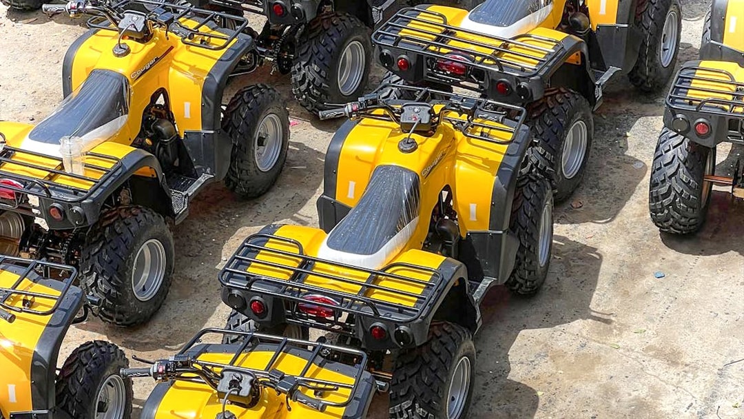 Yellow ATVs lined up for Phuket adventure tour with zipline experience.