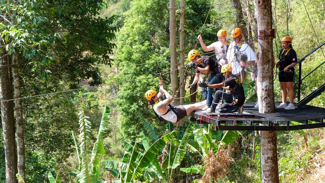 Participants ziplining through lush forest in Phuket.