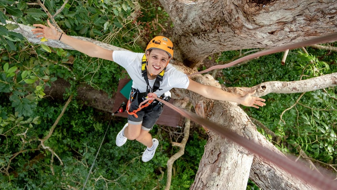 Person ziplining through trees at Erawan Patong Seaview in Phuket.