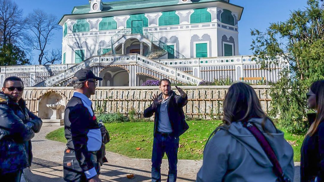 Tour guide explaining in front of a historic building in Cesky Krumlov.
