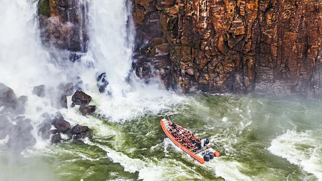 Gran Aventura boat navigating near waterfalls at Argentinian falls.