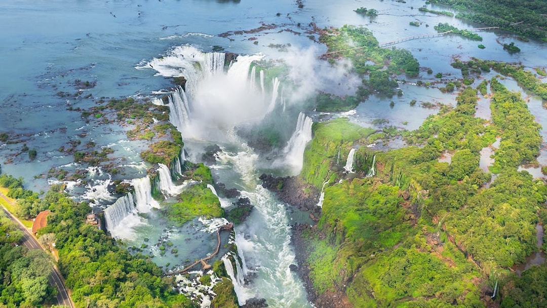 Aerial view of Iguazu Falls with cascading waterfalls and lush greenery in Argentina.
