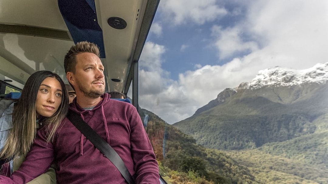 Couple enjoying scenic views on Doubtful Sound Wilderness Cruise from Queenstown.