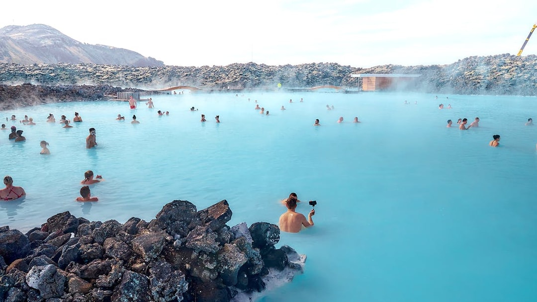 Tourists relaxing in the Blue Lagoon's geothermal waters in Iceland.