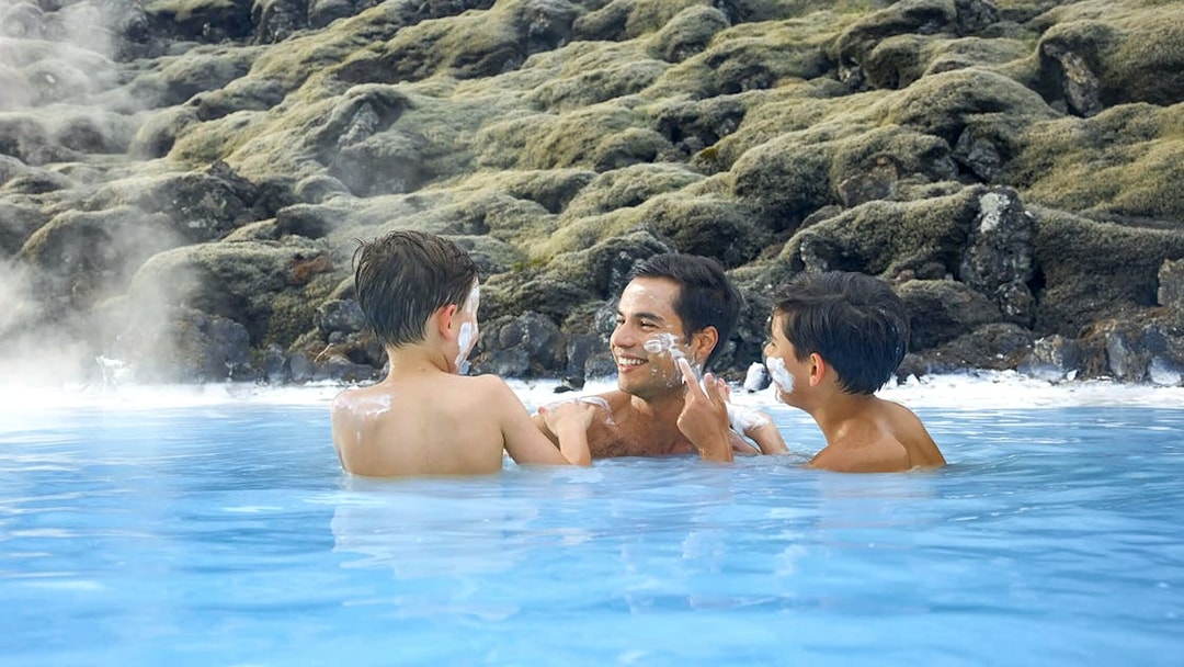 Family enjoying geothermal waters at Blue Lagoon, Iceland.