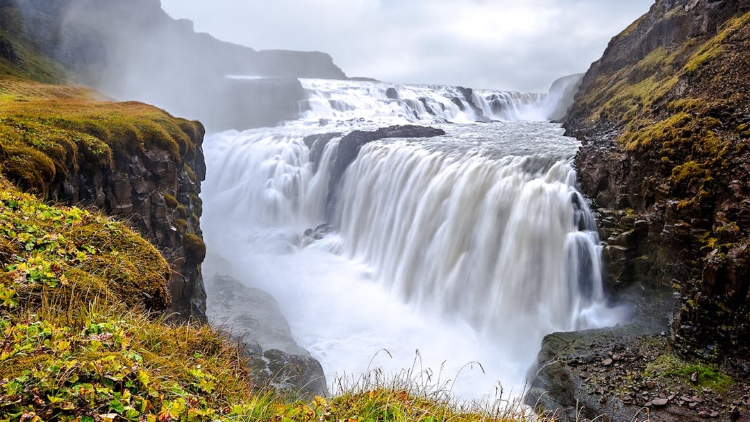 Gullfoss Waterfall cascading over rocky cliffs in Iceland.