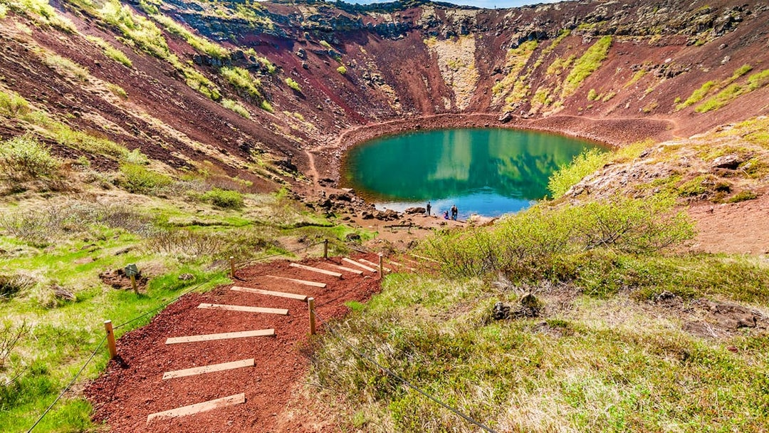 Kerid Crater with turquoise lake and surrounding red volcanic rock in Iceland.