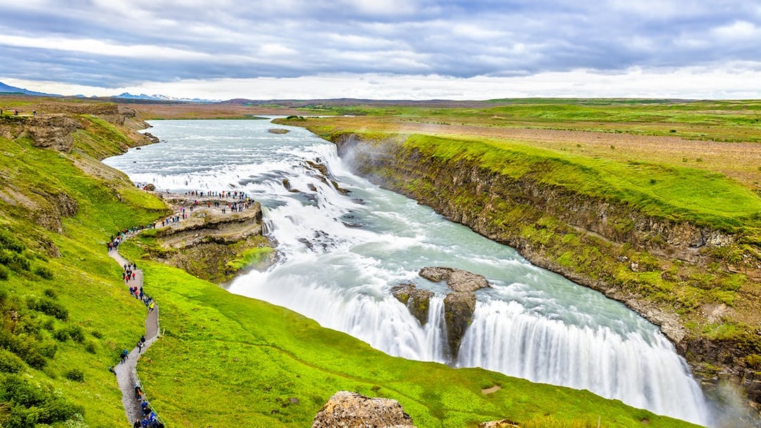 Tourists walking along a path near Gullfoss waterfall, part of Reykjavik Golden Circle Day Tour.