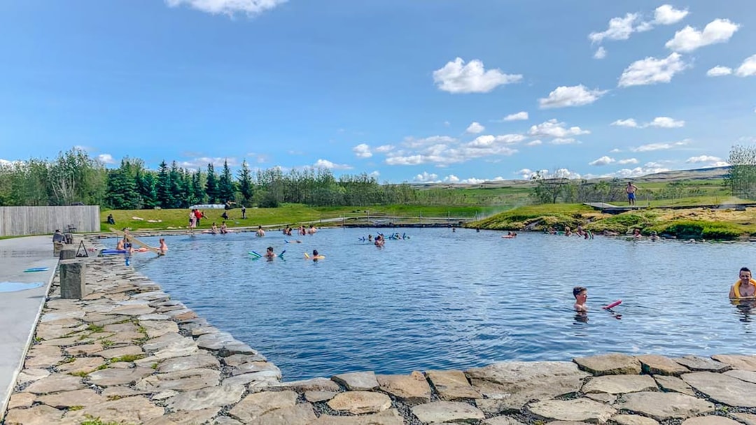 Visitors enjoying the Secret Lagoon's geothermal waters on the Golden Circle near Reykjavik.