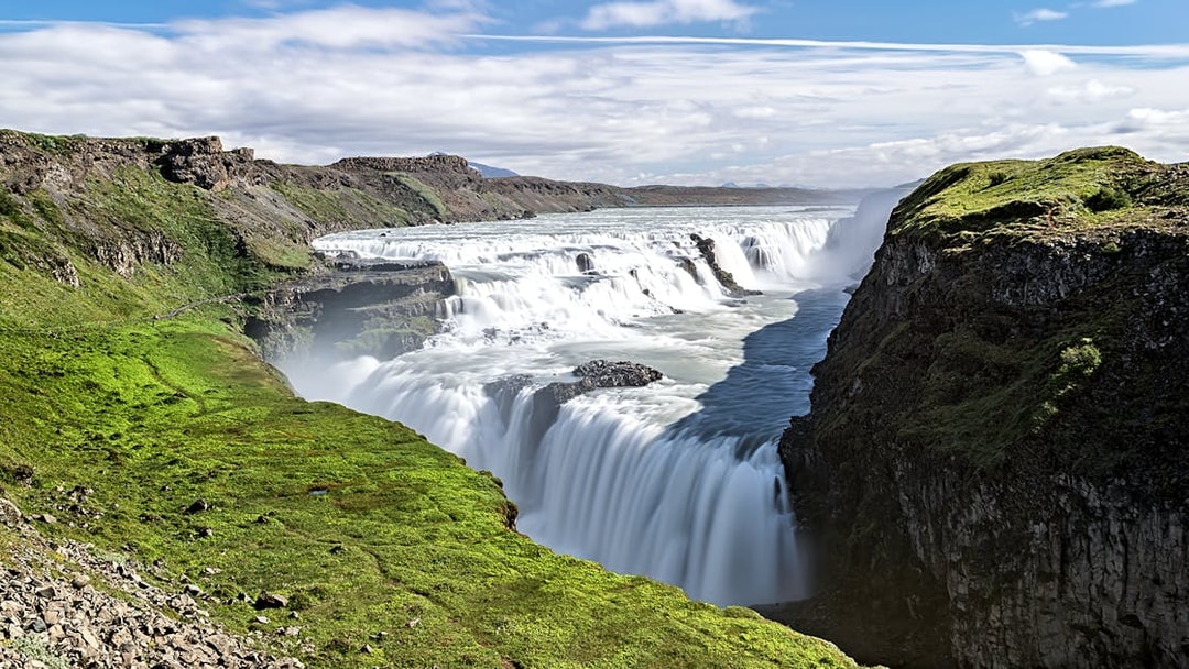 Gullfoss waterfall cascading over rocky cliffs in Iceland.