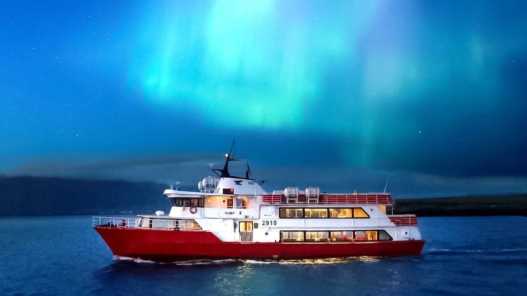 Cruise ship under Northern Lights near Reykjavik, Iceland.