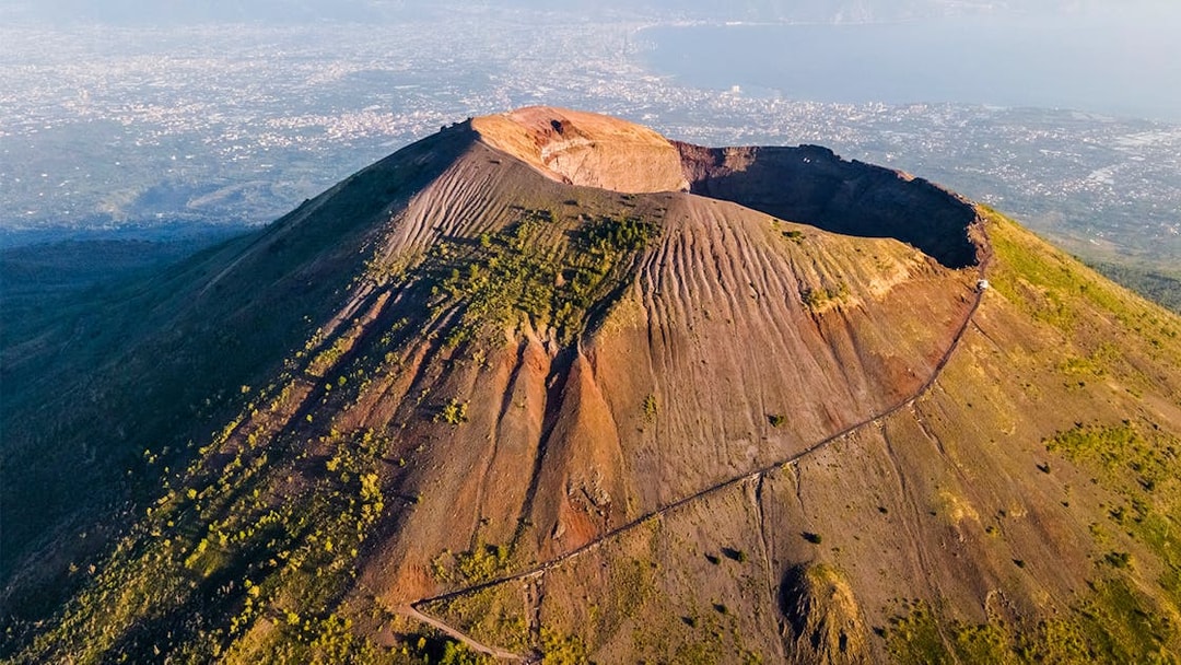 Mount Vesuvius crater with surrounding landscape, part of a Rome to Pompeii and Naples day trip.