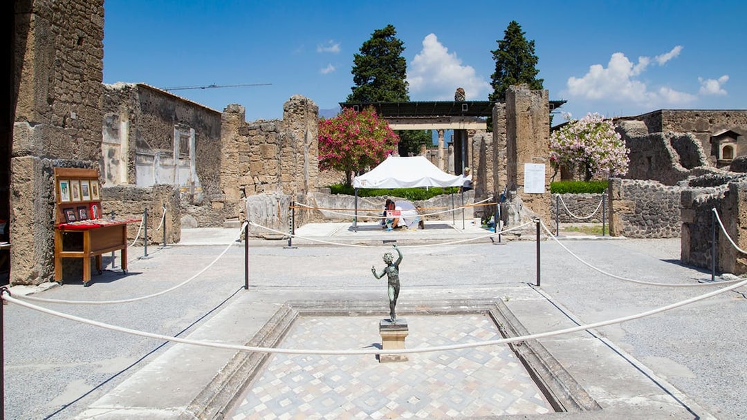 House of the Faun courtyard with bronze statue, Pompeii Ruins.