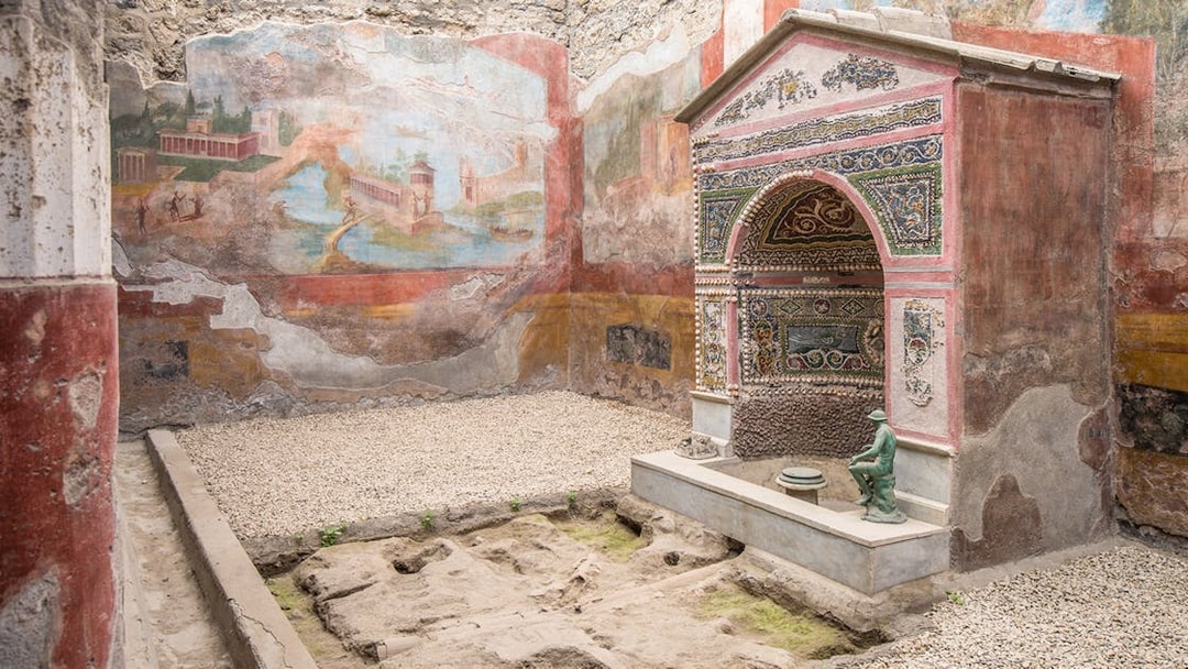 Ancient frescoes and mosaic shrine in the interiors of Pompeii ruins, Italy.