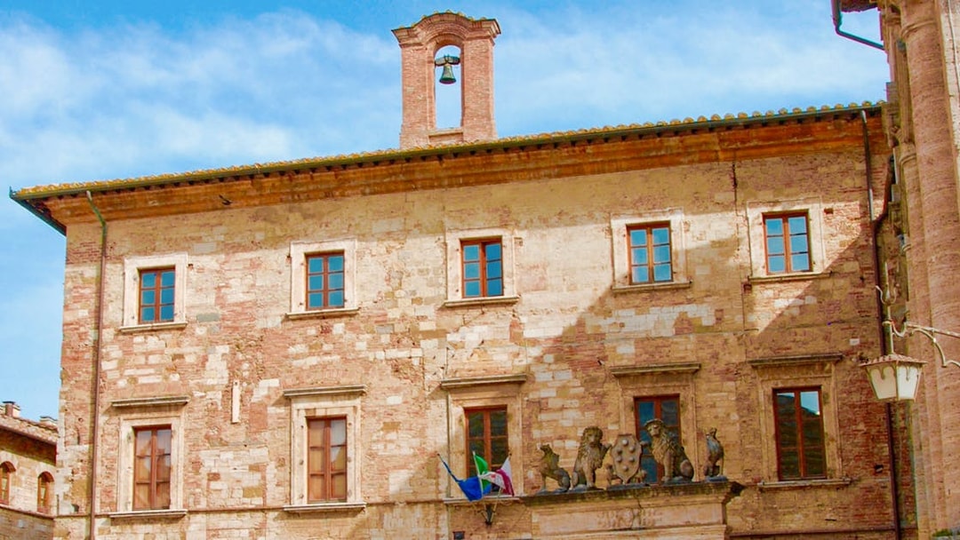 Historic building facade with bell tower in Tuscany, Italy, part of the Best of Tuscany in One Day tour.