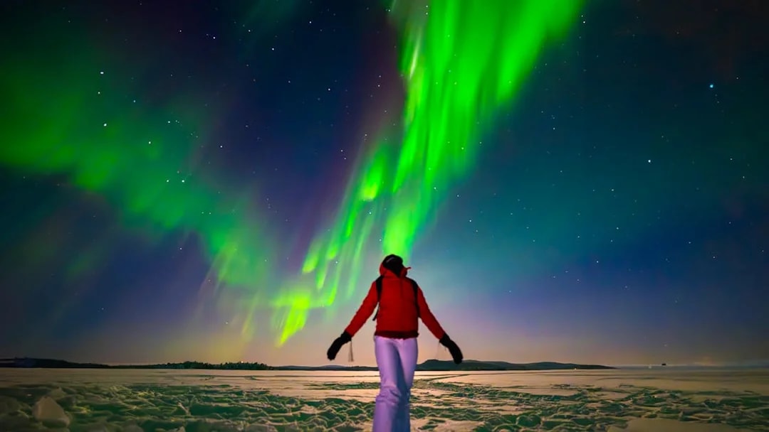 Person viewing Northern Lights during AURORA PRO photography expedition.