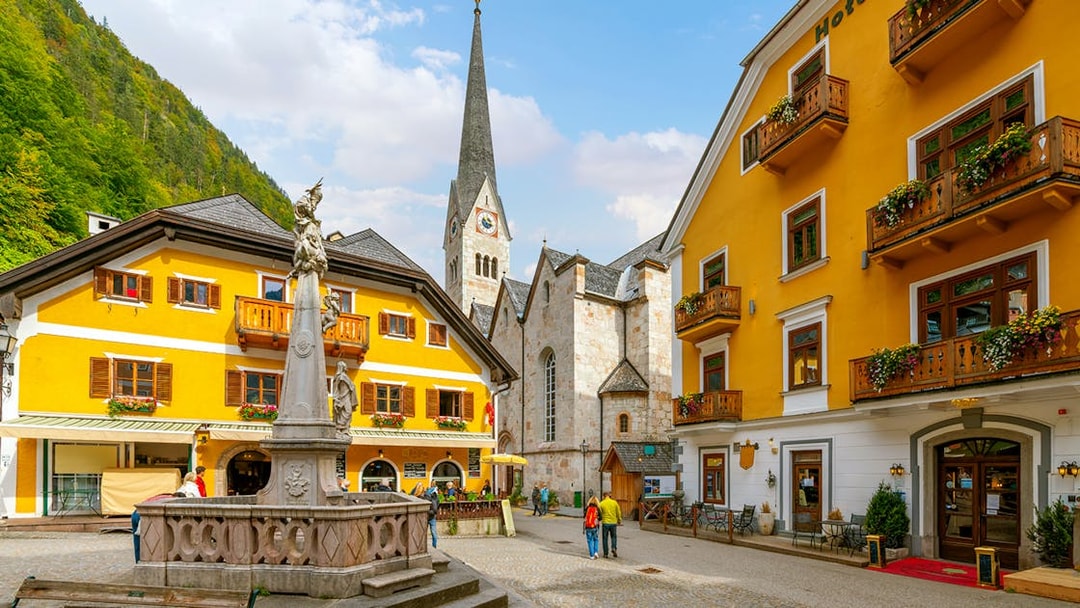 Market Square in Hallstatt with historic buildings and a central fountain.