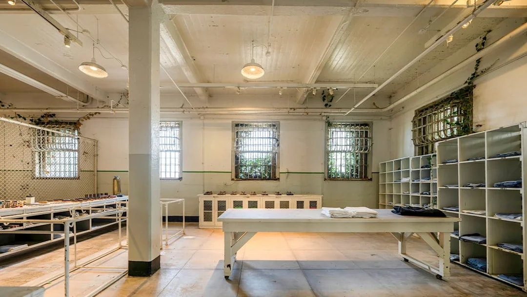 Alcatraz Island prison room with barred windows and storage shelves, San Francisco, California.
