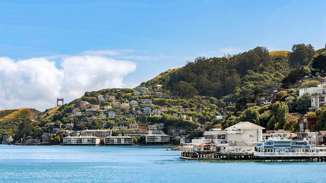 Sausalito Bay Area with hillside homes and partial view of Golden Gate Bridge, San Francisco, California.