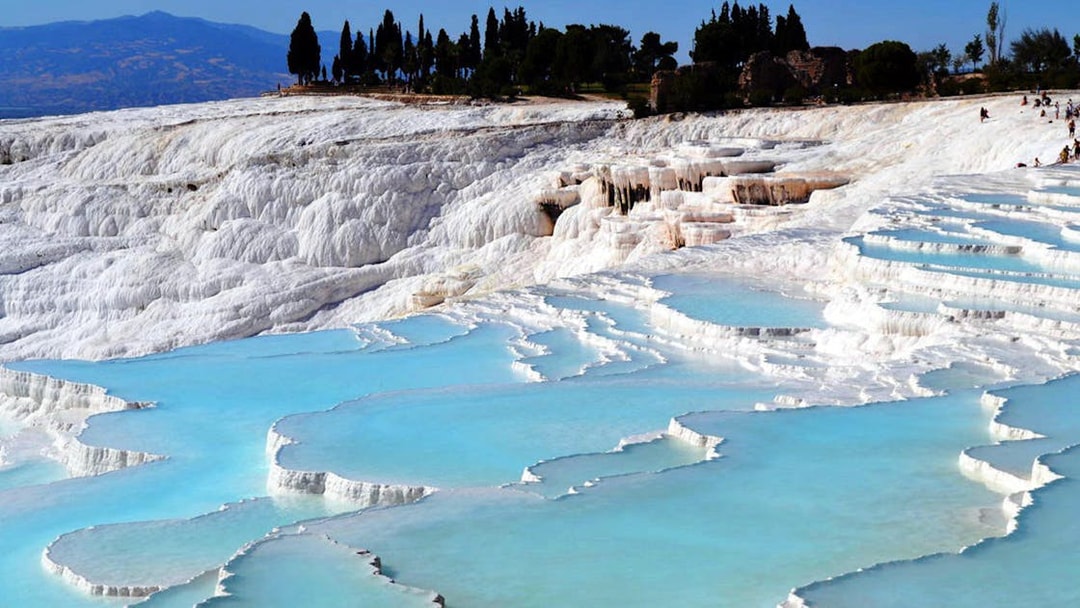 Pamukkale travertine terraces with turquoise thermal pools in Turkey.