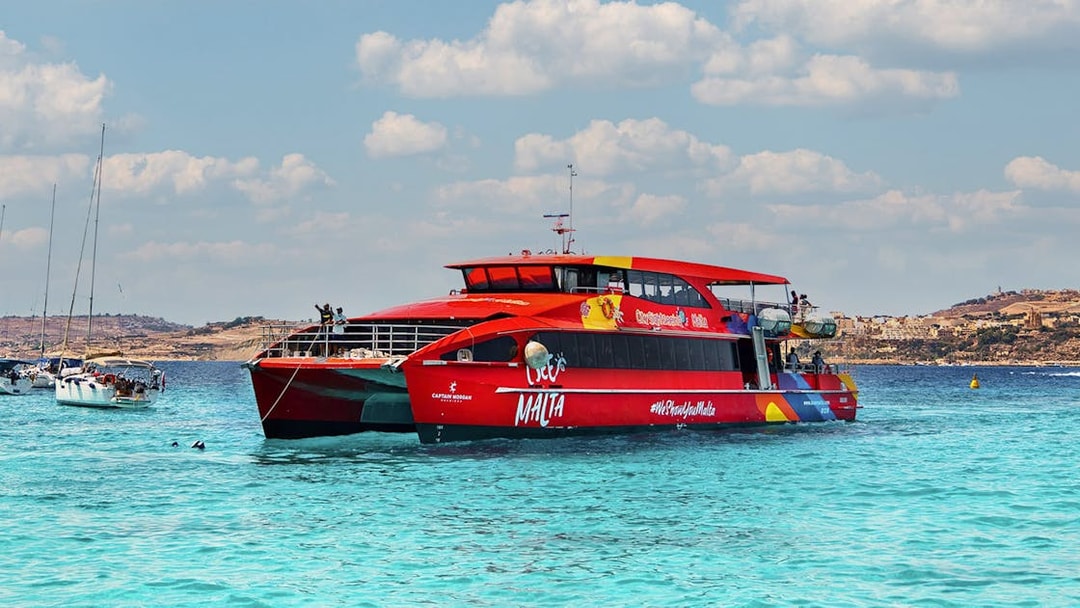 Red cruise boat on Gozo and Comino Blue Lagoon trip, Malta.